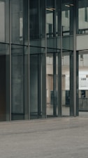 A commercial glass storefront with clean lines and reflective surfaces.