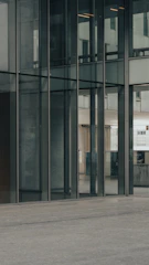 Sleek glass door reflecting a bright, airy interior with minimalist decor.
