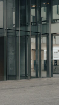 Sleek glass door reflecting a bright, airy interior with minimalist decor.