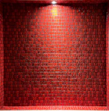 Close-up of sleek black porcelain tiles with glowing red neon edges under soft lighting.