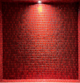 Bright kitchen wall featuring glossy ceramic tiles arranged in a neat, stylish pattern.