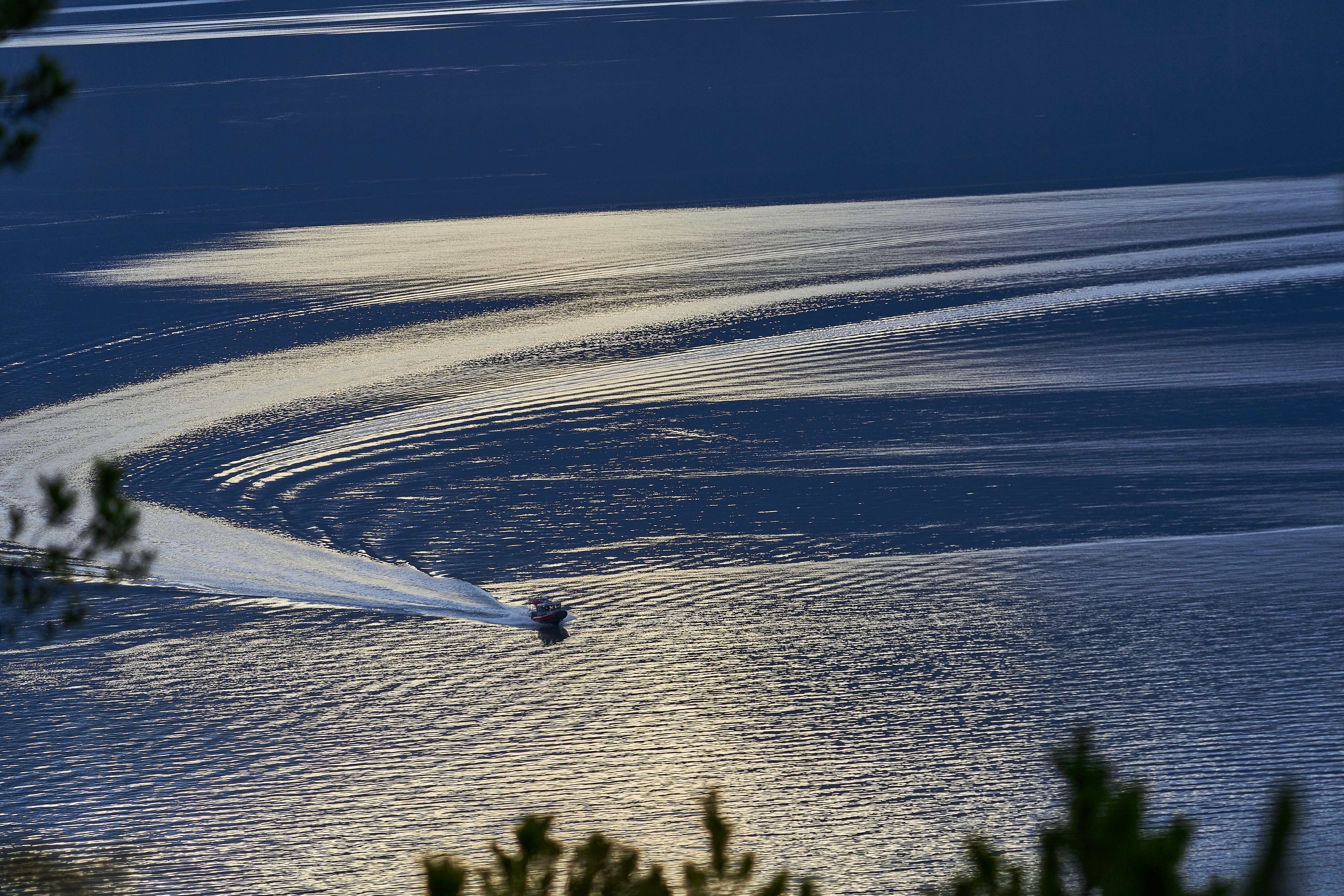 a boat is traveling across a body of water