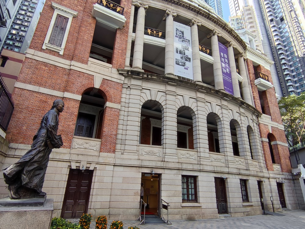 a statue of a woman in front of a building