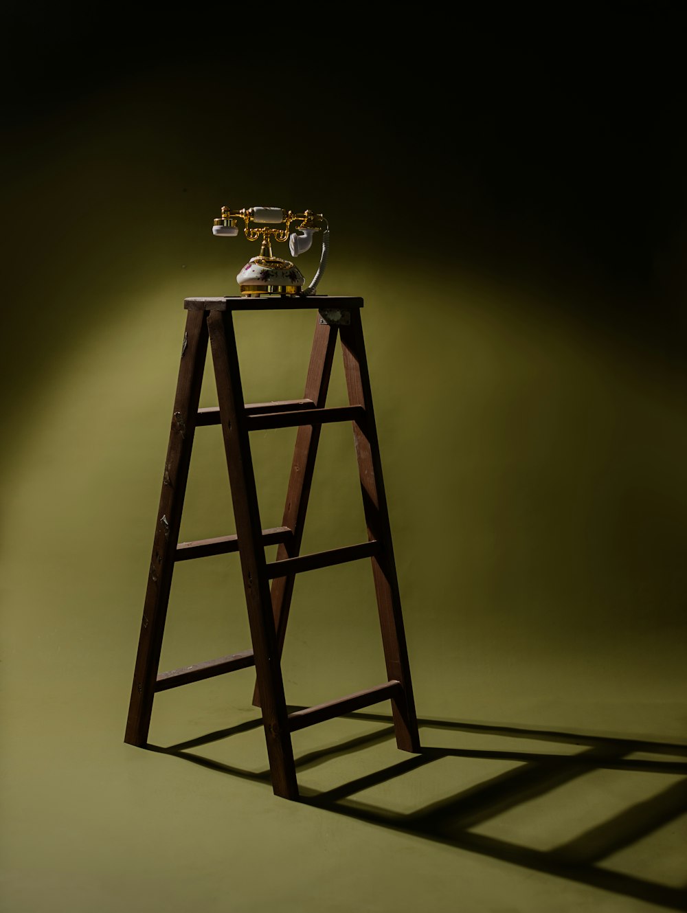 a ladder with a trophy on top of it