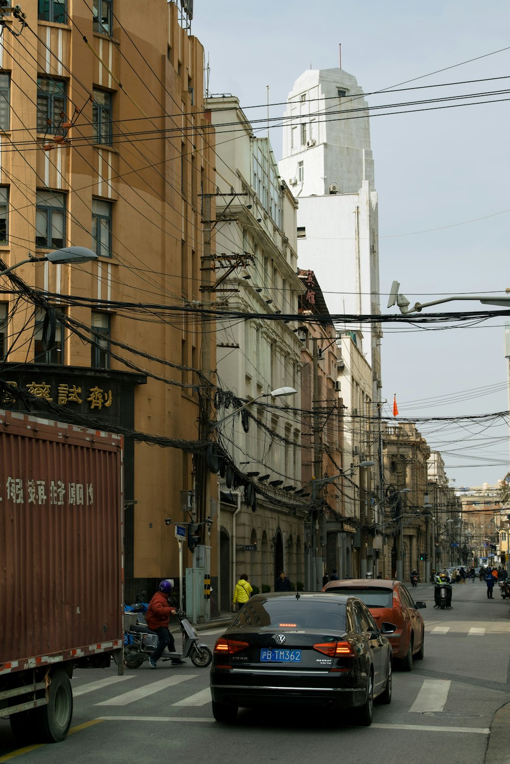 a city street filled with traffic next to tall buildings