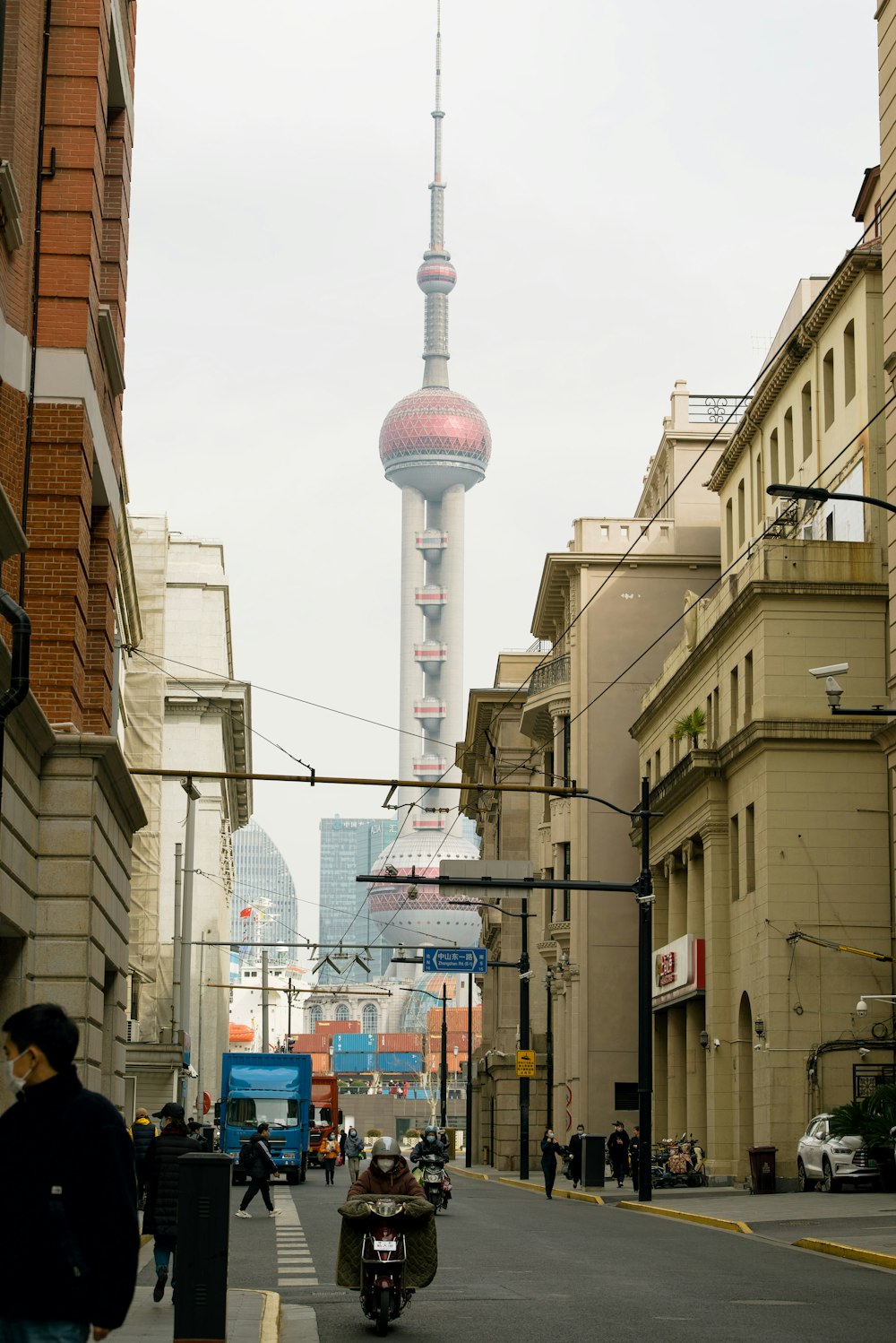 a city street with a tall tower in the background