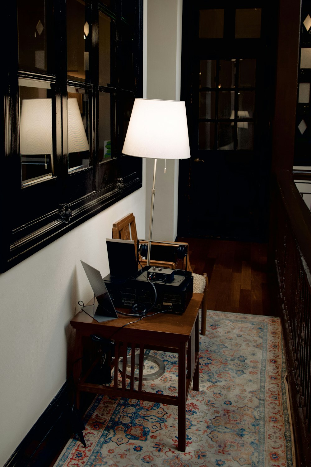a table with a lamp and a laptop on it