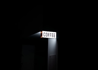 a street sign lit up in the dark