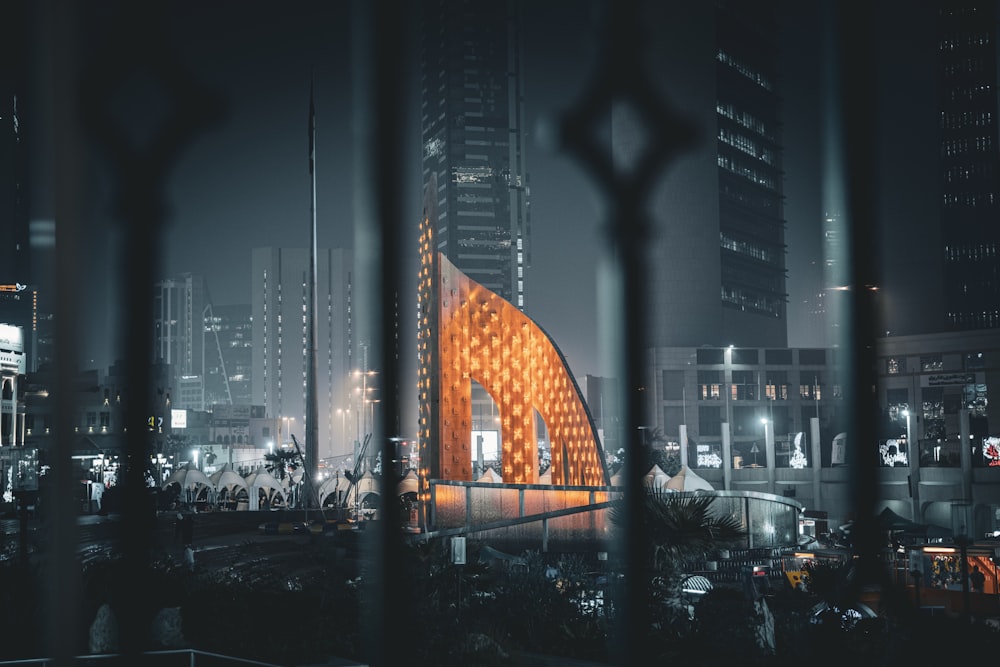 una vista de un edificio a través de una cerca por la noche