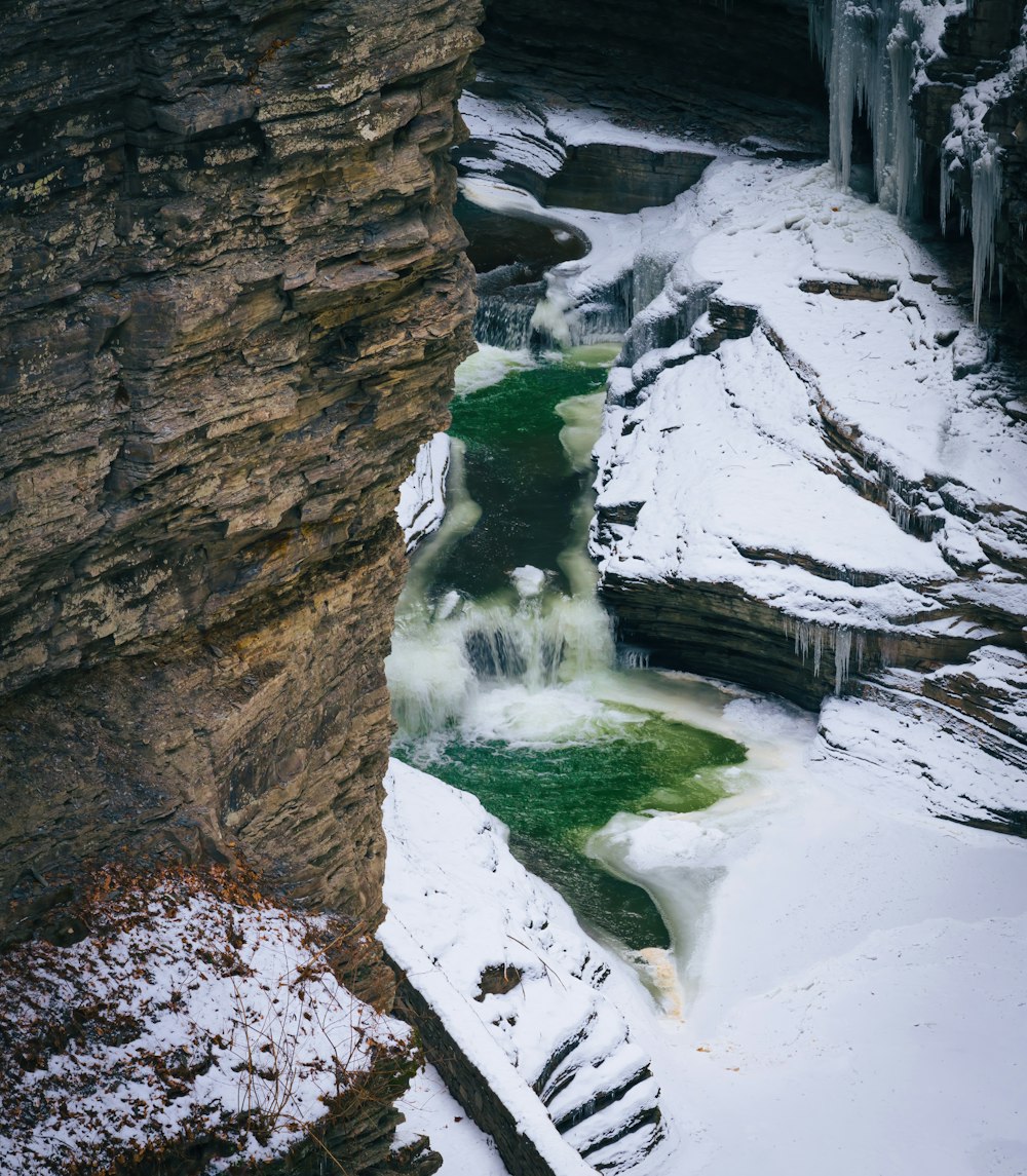 a river running through a snow covered canyon