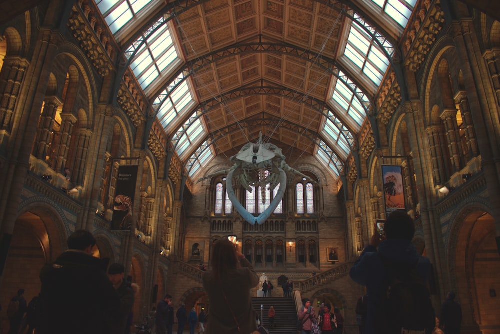 a group of people standing in a large building