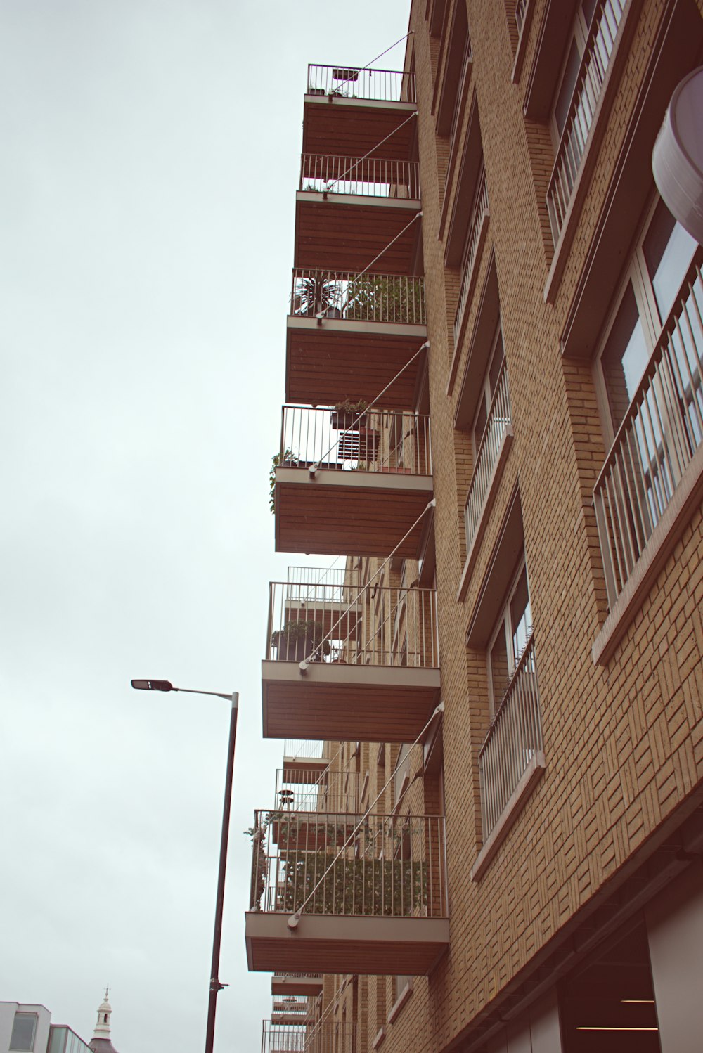 a tall brick building with balconies and balconies