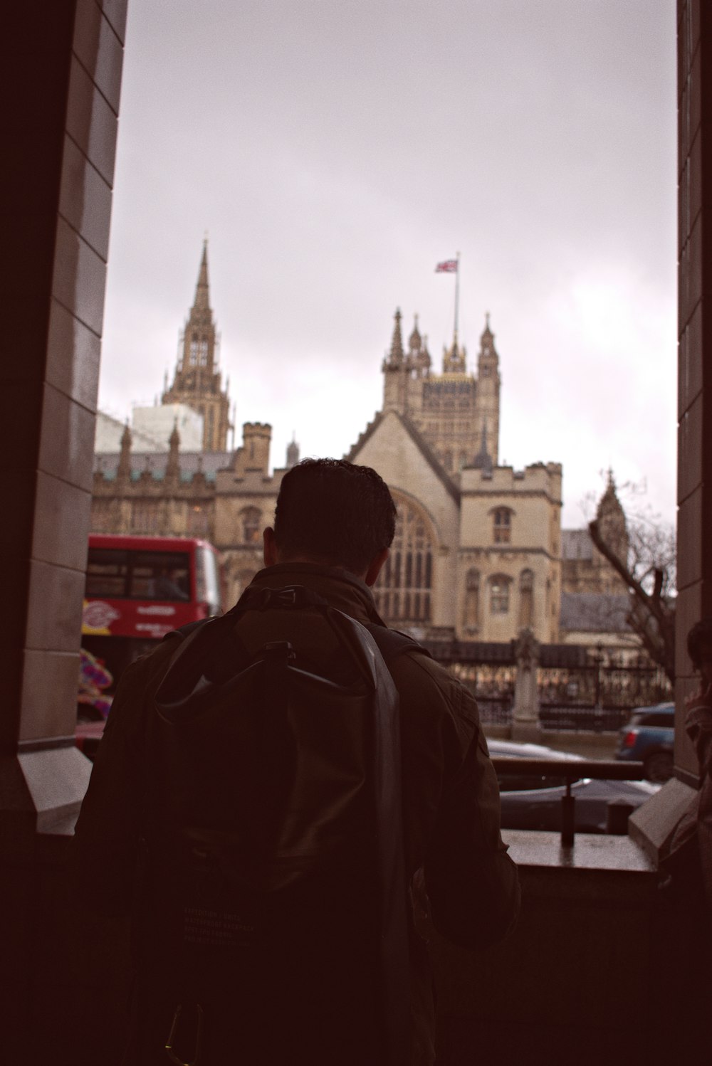 a man looking out a window at a city