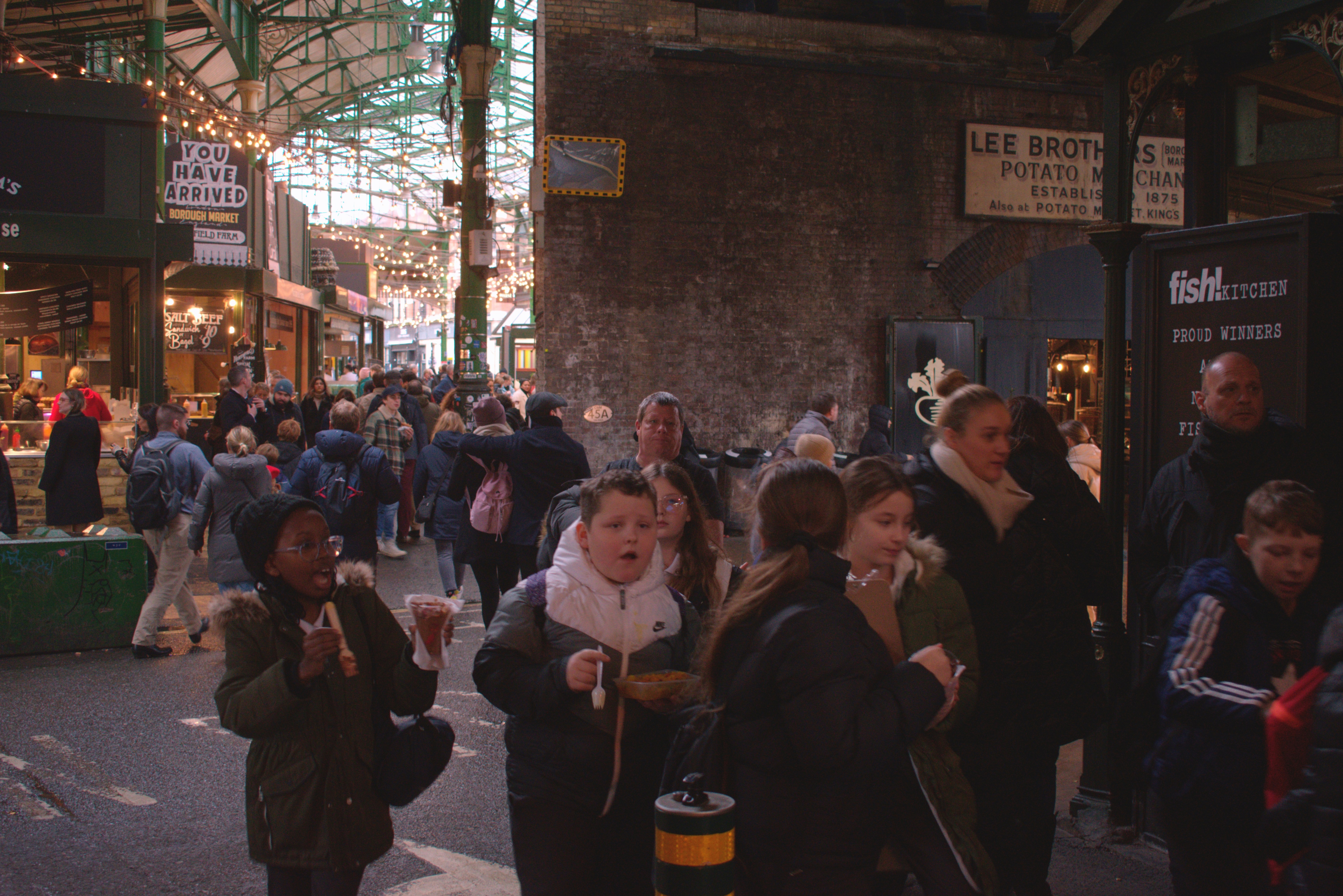 a crowd of people walking down a street