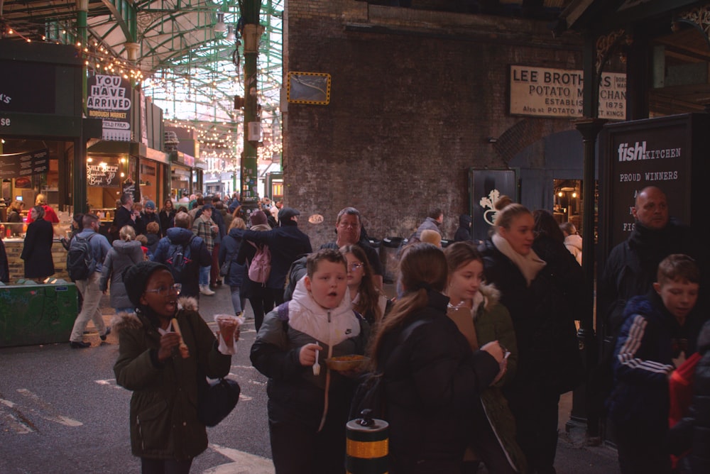 a crowd of people walking down a street