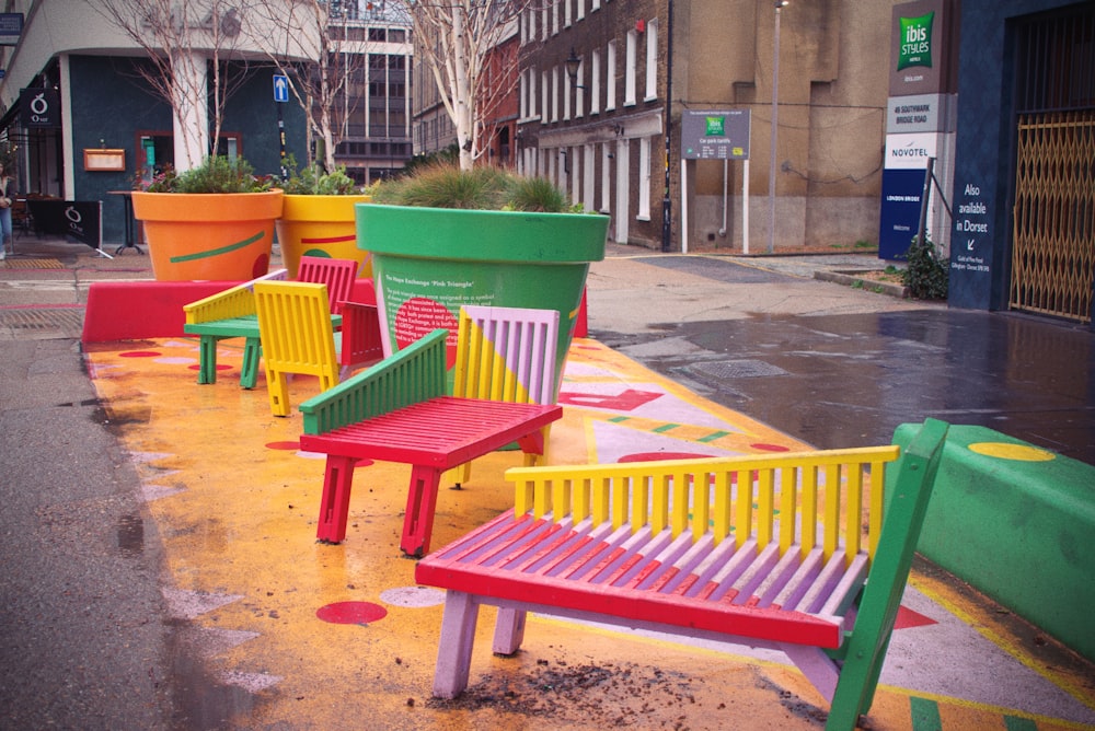 a row of colorful benches on a city street