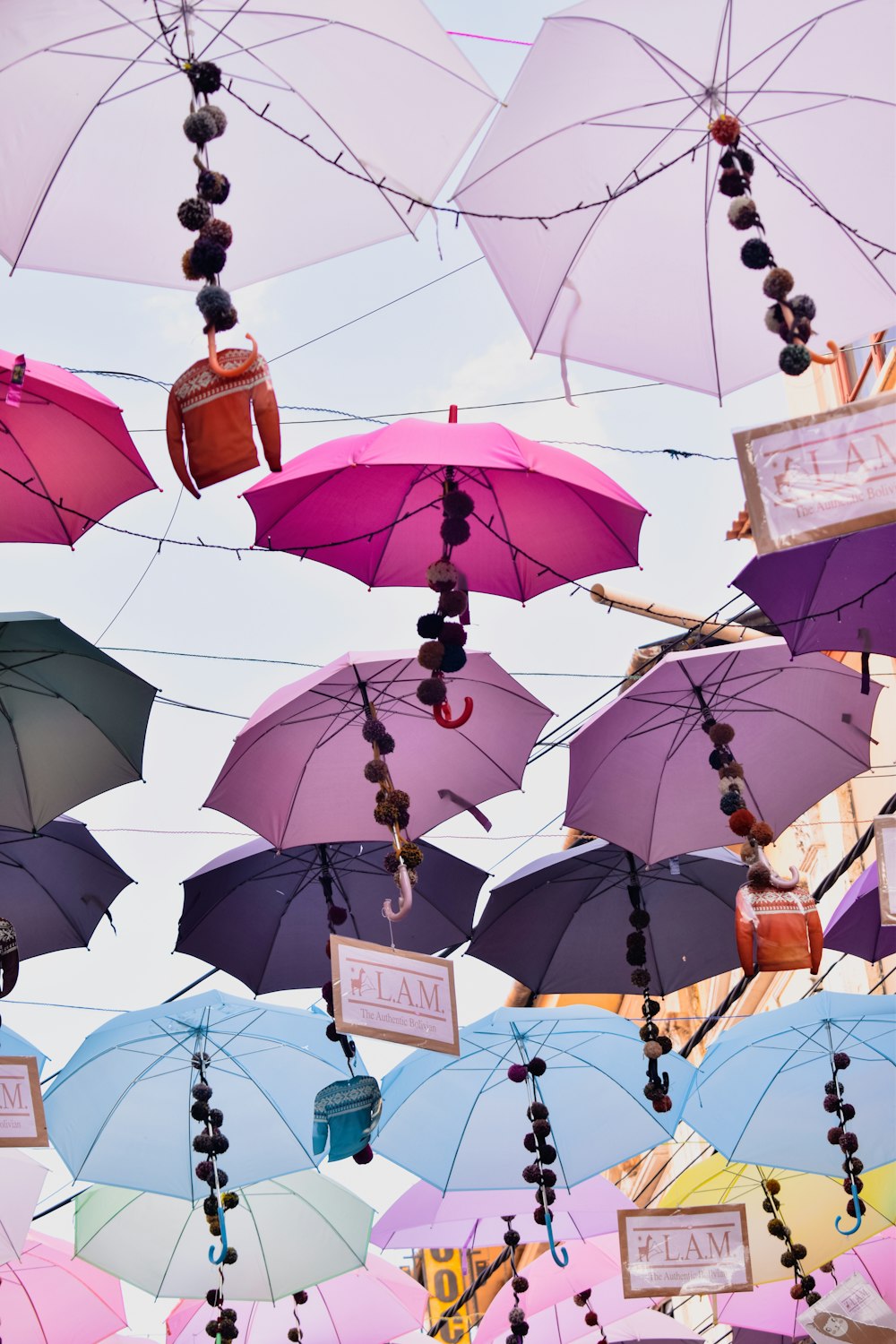 a bunch of umbrellas that are hanging in the air