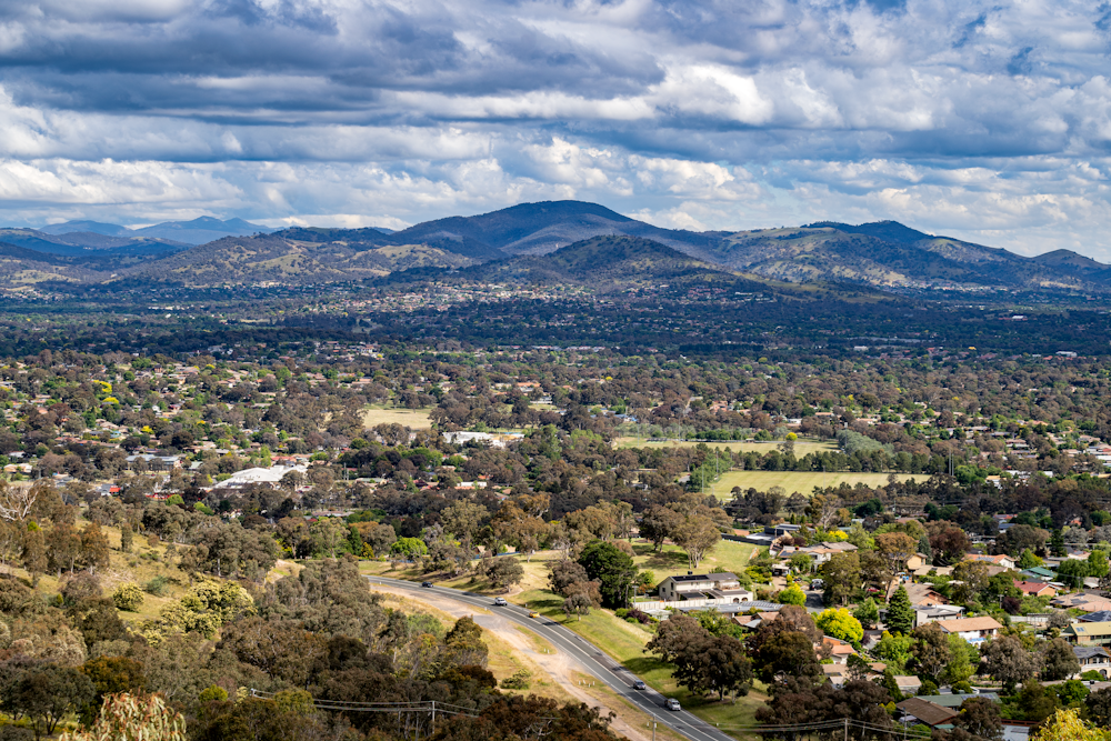 an aerial view of a town surrounded by mountains