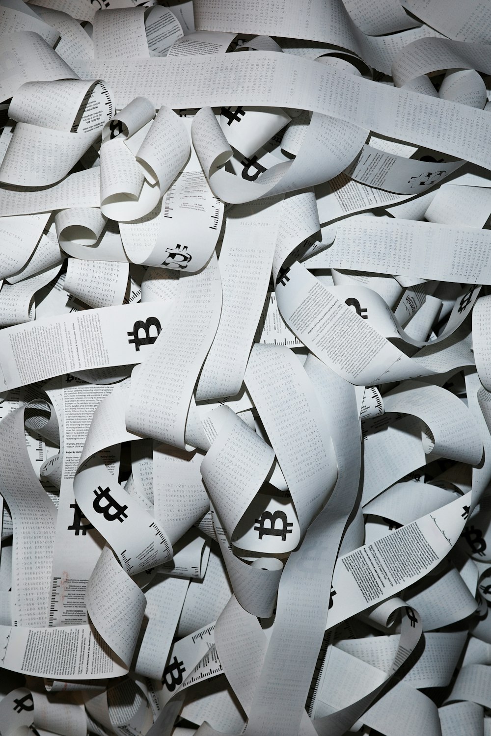 a pile of white ribbons with black letters on them