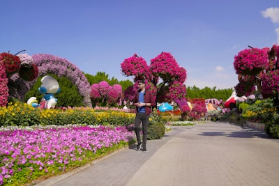 Outdoor garden project displaying colorful flowers and stone pathways under blue sky.