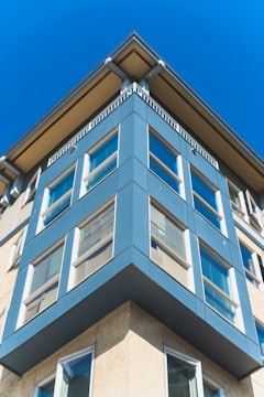 Small commercial building with a modern blue and white facade completed by Coastal Crew.