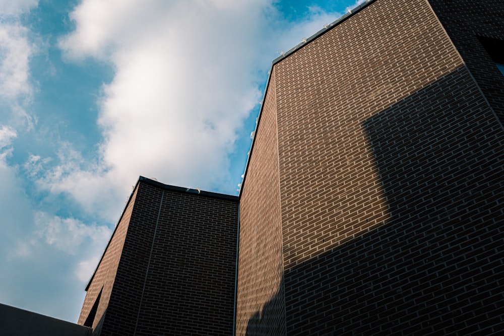 a tall brick building with a sky background