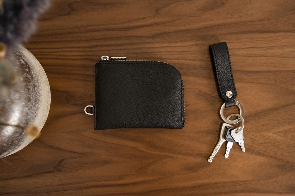 a wallet and a pair of keys on a table