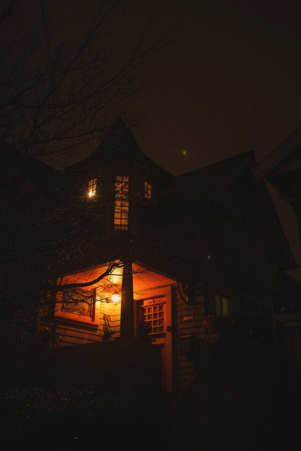 a house lit up at night in the dark