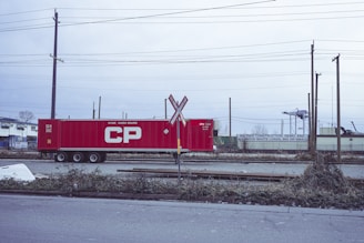 a red train car sitting on the side of a road