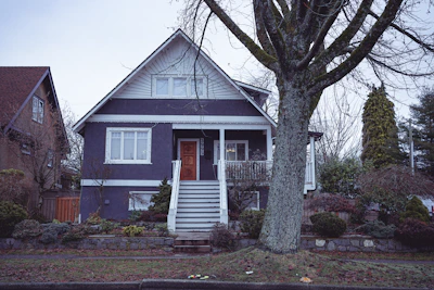 Exterior of a luxury home featuring a smooth, deep navy blue paint finish with crisp white accents.