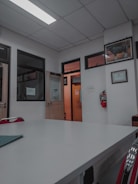 A consultant guiding a team through ISO certification documents in a bright office.