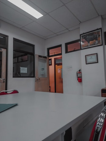 A friendly consultant explaining ISO certification steps to a small business team in a bright office.