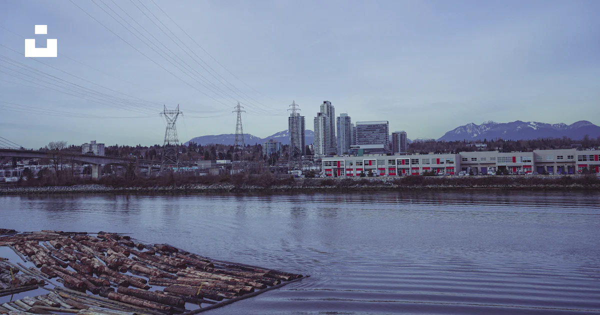 Unsplash Image Riverside A body of water with a city in the background photo – Free Riverside ...