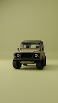A vintage-style off-road vehicle is prominently displayed from the front on a minimalistic, uniform olive green background. The vehicle is tan with a sturdy frame, circular headlights, and rugged tires, creating a sense of adventure and durability.
