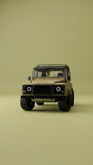 A vintage-style off-road vehicle is prominently displayed from the front on a minimalistic, uniform olive green background. The vehicle is tan with a sturdy frame, circular headlights, and rugged tires, creating a sense of adventure and durability.