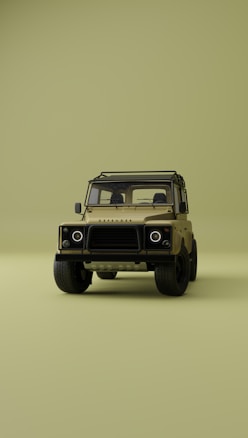 A vintage-style off-road vehicle is prominently displayed from the front on a minimalistic, uniform olive green background. The vehicle is tan with a sturdy frame, circular headlights, and rugged tires, creating a sense of adventure and durability.