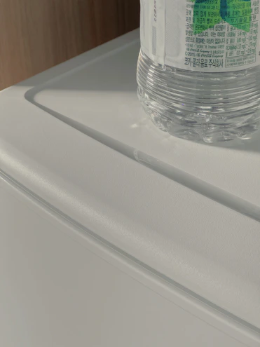 Close-up of a clear bottle of seh multi-functional liquid food enhancer with a soft natural background.