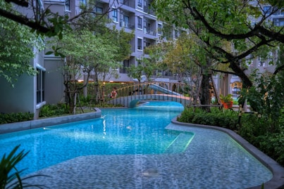 a long pool with a bridge in the middle of it