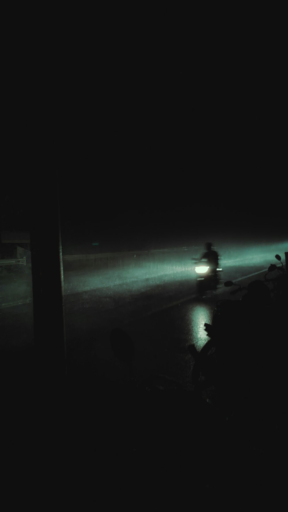 a blurry photo of a person walking on a beach at night