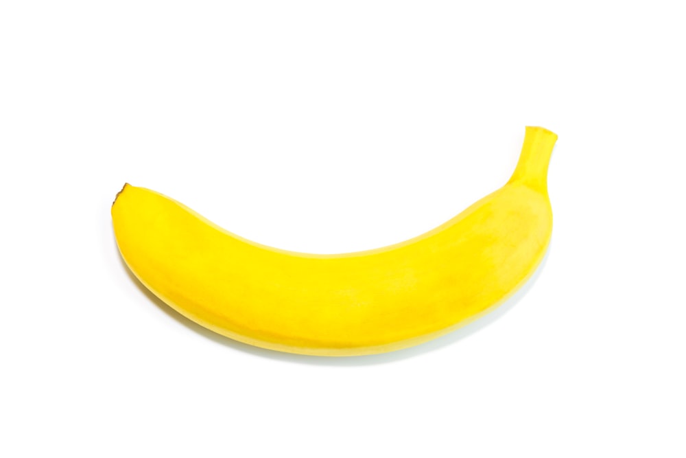 a yellow banana sitting on top of a white table