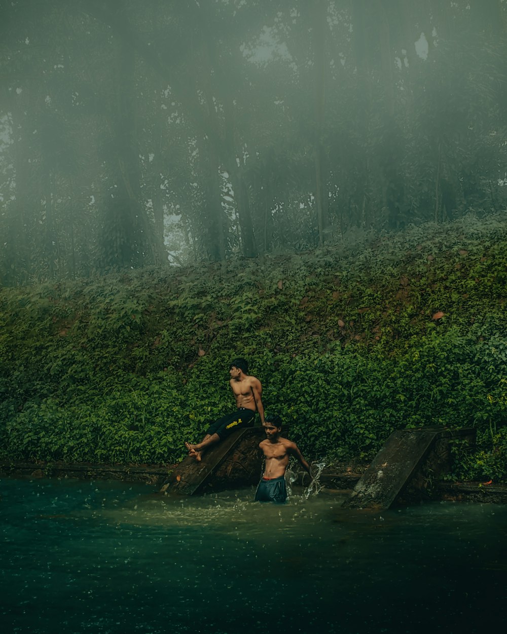 a man standing on top of a wooden boat in a body of water