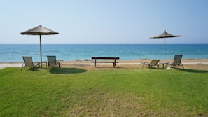 Private terrace with lounge chairs and direct access to the beach.