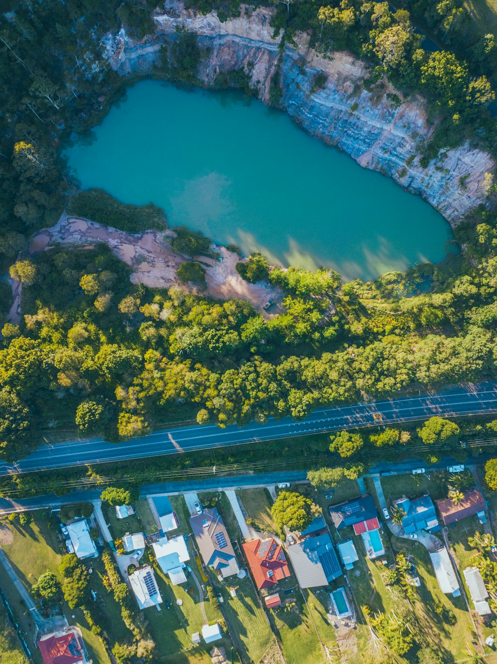 an aerial view of a lake surrounded by trees