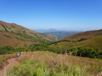 A cheerful group of travelers enjoying a scenic UK countryside tour with rolling hills and historic landmarks.