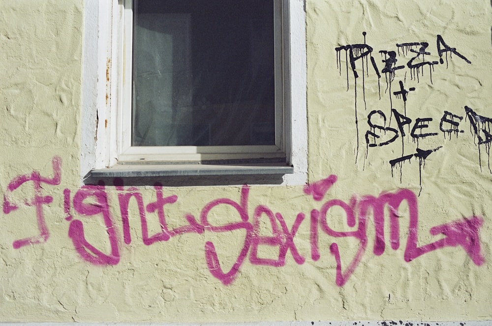 a window with graffiti on the side of a building