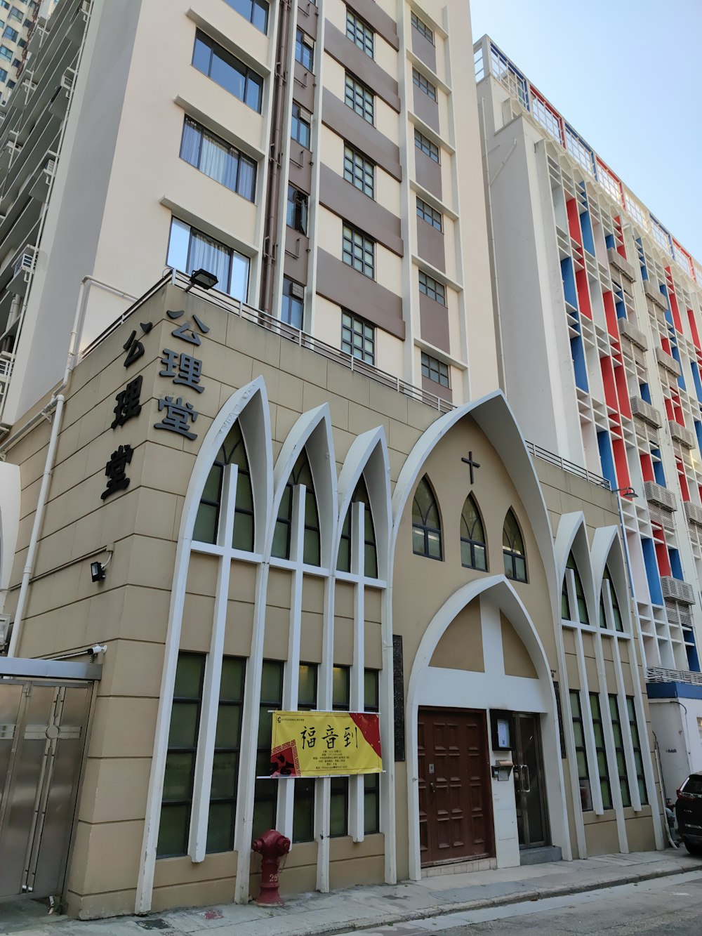 a tall building with arched windows next to a fire hydrant