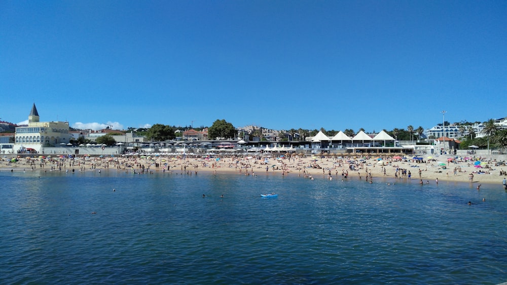 a crowded beach with a lot of people on it