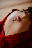 A delicate rose petal falling onto a bare shoulder, capturing a moment of soft affection.