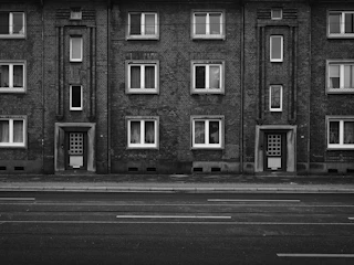 Monochrome sketch of an apartment building entrance with classic doors.