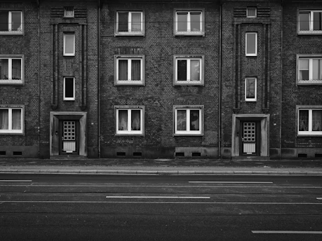 Monochrome sketch of an apartment building entrance with classic doors.
